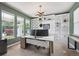Stylish home office with custom built-ins, large windows, and ample natural light at 14049 Detroit Dr, Thornton, CO 80602