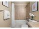 This bathroom features neutral tile, a shower-tub combo, and framed artwork on the walls at 3291 Cascina Cir # D, Highlands Ranch, CO 80126