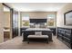 Elegant bedroom with dark wood furniture and a ensuite bathroom featuring a tub at 3291 Cascina Cir # D, Highlands Ranch, CO 80126