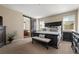 Spacious bedroom with dark furniture, sliding barn door and carpeted floors at 3291 Cascina Cir # D, Highlands Ranch, CO 80126