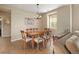 Elegant dining room with a wooden table, upholstered chairs, a chandelier, and hardwood flooring, perfect for gatherings at 3291 Cascina Cir # D, Highlands Ranch, CO 80126
