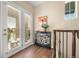 Elegant hallway with hardwood floors, staircase, french doors, and an ornate console table at 3291 Cascina Cir # D, Highlands Ranch, CO 80126