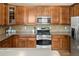 Kitchen with stainless steel appliances, quartz countertops and dark wood cabinetry at 3291 Cascina Cir # D, Highlands Ranch, CO 80126