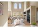 Inviting living room with a fireplace, comfortable seating, hardwood floors, and tall windows for ample natural light at 3291 Cascina Cir # D, Highlands Ranch, CO 80126