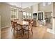 Open-concept design with a dining area flowing into a living room with a fireplace and comfortable seating arrangement at 3291 Cascina Cir # D, Highlands Ranch, CO 80126