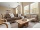Cozy living room featuring a comfortable sofa, a decorative rug, and natural light from large windows at 3291 Cascina Cir # D, Highlands Ranch, CO 80126