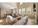 Bright living room with high ceilings, large windows, comfortable seating, a wooden coffee table, and hardwood floors at 3291 Cascina Cir # D, Highlands Ranch, CO 80126