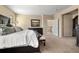Comfortable primary bedroom with an open doorway, dark wood furniture, and neutral decor at 3291 Cascina Cir # D, Highlands Ranch, CO 80126