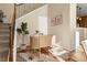 Home office nook under the stairs with hardwood floors, desk and decorative rug at 3291 Cascina Cir # D, Highlands Ranch, CO 80126