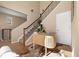 Hallway office space with hardwood floors, modern desk, decor and staircase at 3291 Cascina Cir # D, Highlands Ranch, CO 80126