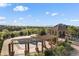 A stunning pool area features a pergola, a nearby gazebo, and well-manicured landscaping, all with beautiful mountain views at 3291 Cascina Cir # D, Highlands Ranch, CO 80126