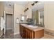 Spacious primary bathroom with double sink vanity and open doorway at 3291 Cascina Cir # D, Highlands Ranch, CO 80126