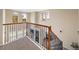 Second story view of the staircase with wood and iron banisters and large windows at 3291 Cascina Cir # D, Highlands Ranch, CO 80126
