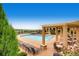Enjoy this beautiful swimming pool with lounge chairs and shaded pergola with table and chairs, perfect for relaxing outdoors at 3291 Cascina Cir # D, Highlands Ranch, CO 80126