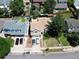 Aerial shot of the home's facade, driveway with multiple cars, landscaping, and neighborhood setting at 20391 E 42Nd Ave, Denver, CO 80249