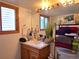 Functional bathroom featuring a vanity with a sink, mirror, and toiletries at 20391 E 42Nd Ave, Denver, CO 80249