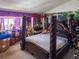 Bedroom featuring dark wood poster bed and unique decor at 20391 E 42Nd Ave, Denver, CO 80249