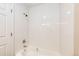 Bright white shower/tub combination with white tiled walls and modern fixtures at 17004 E Tennessee Dr # 212, Aurora, CO 80017