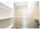Bright walk-in closet with built-in shelving and wood-style floors at 17004 E Tennessee Dr # 212, Aurora, CO 80017