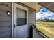 Charming home entrance with a well-lit porch, stylish front door, and peaceful neighborhood view at 17004 E Tennessee Dr # 212, Aurora, CO 80017