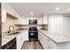 U-shaped kitchen featuring new countertops, modern appliances, and ample storage at 17004 E Tennessee Dr # 212, Aurora, CO 80017