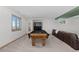 Basement featuring a billiards table, couch, and neutral carpeted floors at 12017 W 54Th Dr, Arvada, CO 80002