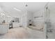 Bright bathroom showcasing double vanities, a soaking tub, and glass enclosed shower at 12017 W 54Th Dr, Arvada, CO 80002