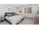 Bedroom featuring a king bed, large window, and carpeted floors at 12017 W 54Th Dr, Arvada, CO 80002