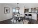 Cozy breakfast nook featuring a modern light fixture and sliding glass doors leading to an outdoor deck at 12017 W 54Th Dr, Arvada, CO 80002