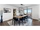 Modern dining room with sleek light fixture, hardwood floors, and access to an outdoor deck for entertaining at 12017 W 54Th Dr, Arvada, CO 80002