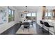 Modern dining room features hardwood floors, contemporary lighting, and a door leading to an outdoor patio at 12017 W 54Th Dr, Arvada, CO 80002