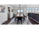Bright dining area with modern lighting, hardwood floors, and a sliding door to a deck with scenic views at 12017 W 54Th Dr, Arvada, CO 80002