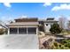 Charming home showcasing a three-car garage, tile roof and well-maintained landscaping at 12017 W 54Th Dr, Arvada, CO 80002