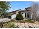 Exterior view of home with three car garage and beautiful landscaping at 12017 W 54Th Dr, Arvada, CO 80002