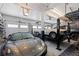 Bright and spacious garage with car lifts and multiple vehicles at 12017 W 54Th Dr, Arvada, CO 80002