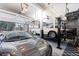 Spacious garage with car lifts, epoxy flooring and multiple vehicles at 12017 W 54Th Dr, Arvada, CO 80002