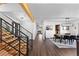 Open hallway with wood and metal staircase leading to dining room, creating a seamless flow throughout the home at 12017 W 54Th Dr, Arvada, CO 80002