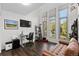 Well-lit home office with a large window, a modern desk, and comfortable seating at 12017 W 54Th Dr, Arvada, CO 80002