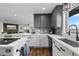 Bright kitchen showcasing white countertops, gray cabinets, stainless steel appliances, and modern fixtures at 12017 W 54Th Dr, Arvada, CO 80002