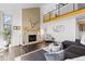 Living room with large windows, a fireplace and vaulted ceilings at 12017 W 54Th Dr, Arvada, CO 80002