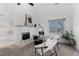 Cozy living room with fireplace, modern chair, and large window offering natural light at 12017 W 54Th Dr, Arvada, CO 80002