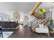 Open-concept living space featuring wood floors, staircase and brick fireplace at 12017 W 54Th Dr, Arvada, CO 80002