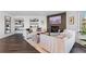 Bright living room with a brick fireplace, built-in shelving, and comfortable seating at 12017 W 54Th Dr, Arvada, CO 80002
