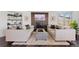 Spacious living room featuring a brick fireplace, plush sofas, and lots of natural light at 12017 W 54Th Dr, Arvada, CO 80002