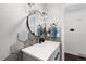 Stylish powder room features a hexagon tile backsplash, modern fixtures, and sleek countertop at 12017 W 54Th Dr, Arvada, CO 80002