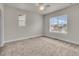 Spacious bedroom with neutral carpet, ceiling fan, and two windows that let in lots of natural light at 3372 Central Park Blvd, Denver, CO 80238