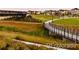 Scenic view of the community walking path and foot bridge in a lush, green setting at 3372 Central Park Blvd, Denver, CO 80238