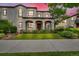 Charming two-story stucco home boasts a covered porch, manicured lawn, and inviting curb appeal at sunset at 3372 Central Park Blvd, Denver, CO 80238