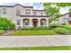 Charming two-story stucco home boasts a covered porch, manicured lawn, and inviting curb appeal at 3372 Central Park Blvd, Denver, CO 80238