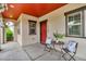 Inviting covered front porch with decorative black chairs and table at 3372 Central Park Blvd, Denver, CO 80238
